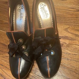 Black shoes trimmed with tan.